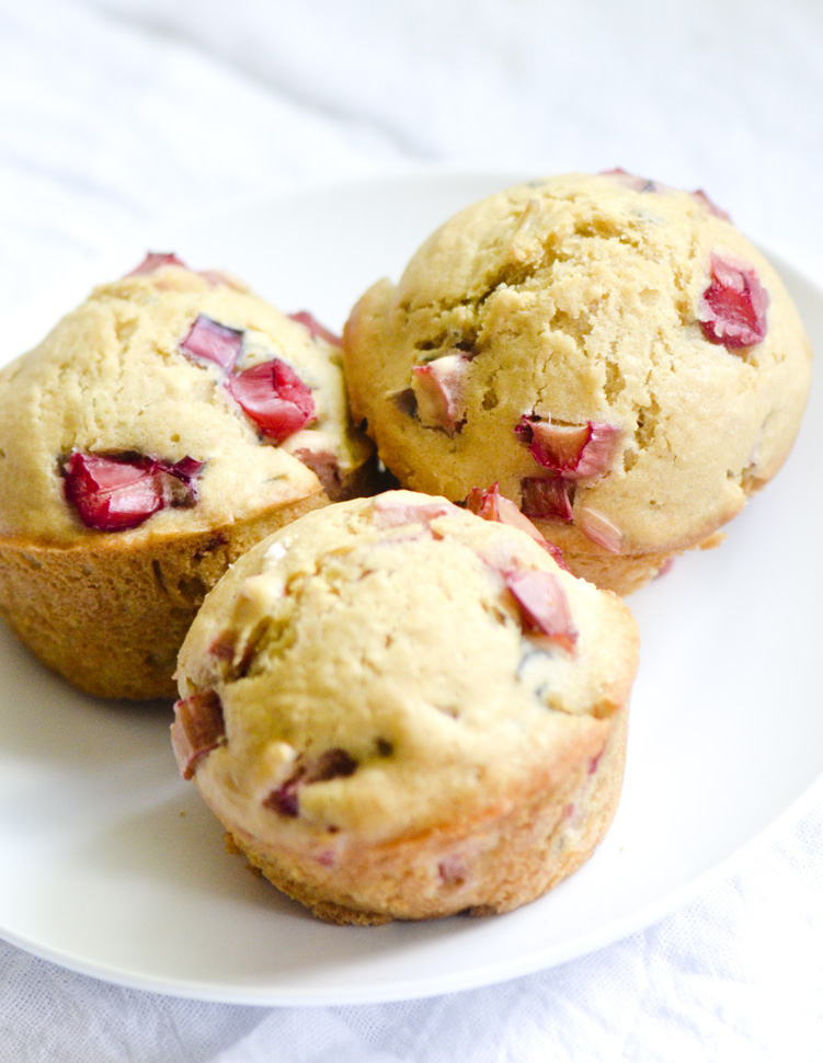 3 Rhubarb muffins sitting on an white plate. 