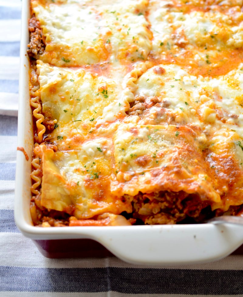 trisha yearwood's cowboy lasagna  in a white casserole dish. 