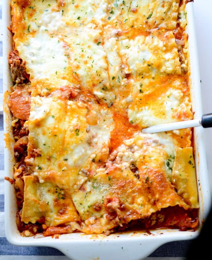 trisha yearwood's cowboy lasagna  in a white casserole dish. 