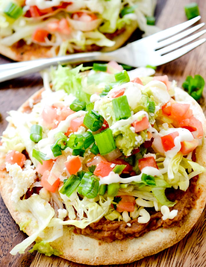 These tostadas are topped with spicy beans, cotija cheese, pico de Gallo, and fresh iceberg lettuce. They are great for a meatless Monday or Taco Tuesday and ready in under 20 minutes.