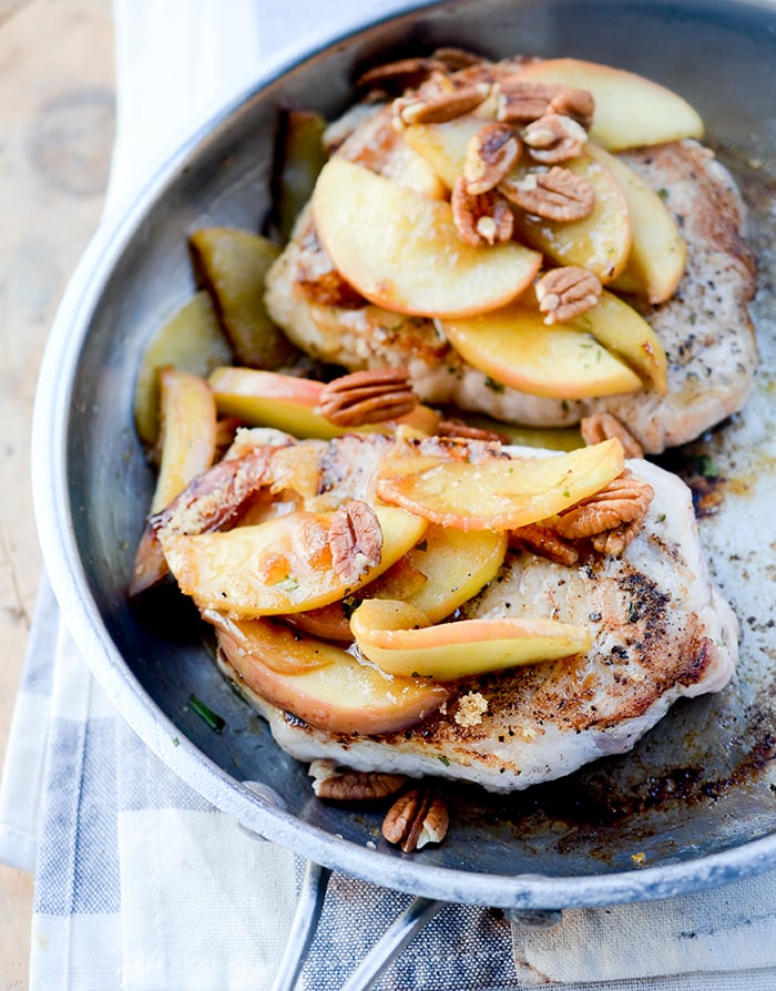 One Skillet Pork Chops and Apples - Apples and Pork Chops cooked together in one skillet and topped with pecans and maple syrup! Hardly no clean up necessary. 