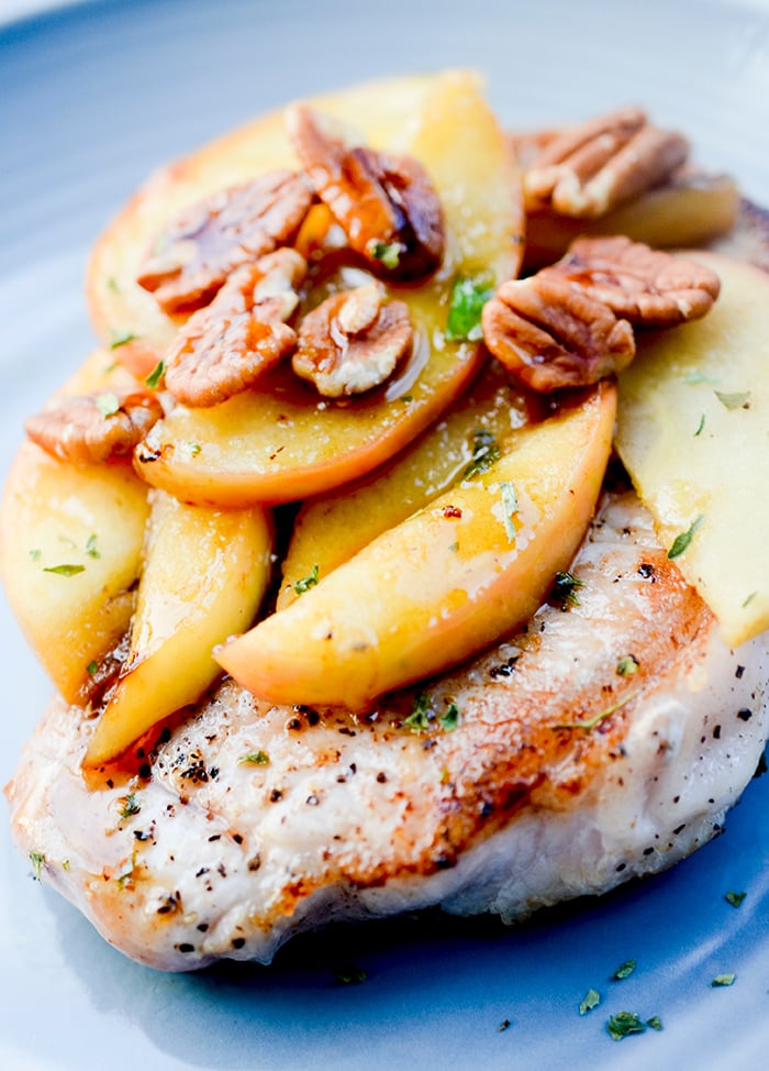 One Skillet Pork Chops and Apples - Apples and Pork Chops cooked together in one skillet and topped with pecans and maple syrup! Hardly no clean up necessary. 