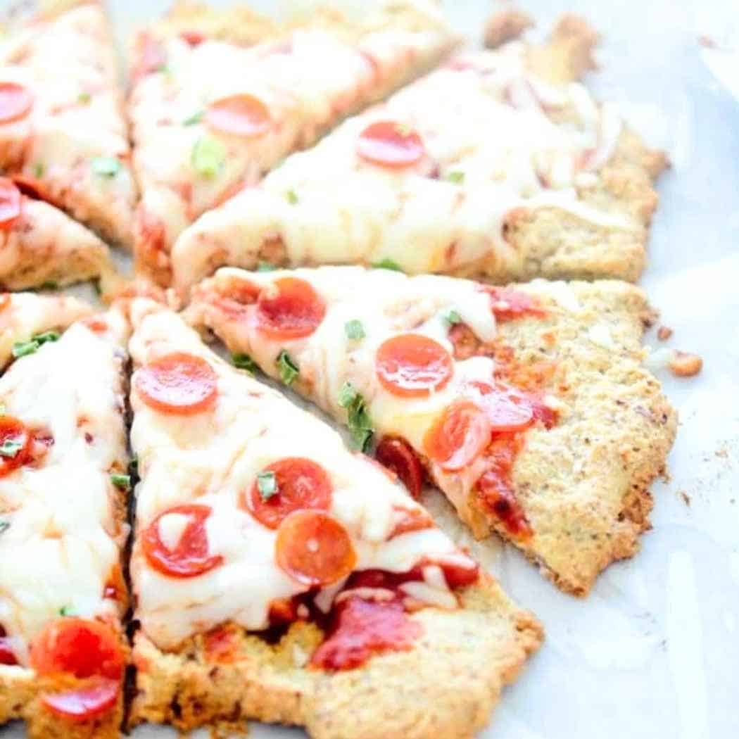 Low carb almond flour pizza crust topped with cheese and pepperoni.