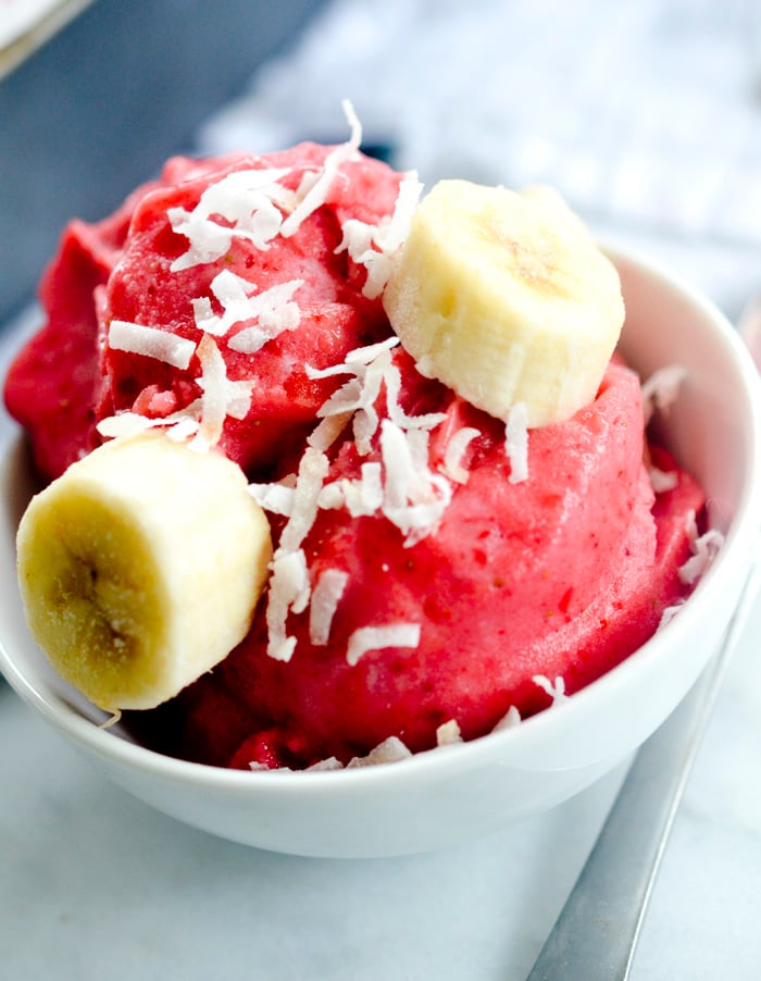 Fresh strawberry banana sorbet topped with fresh banana slices and coconut. 