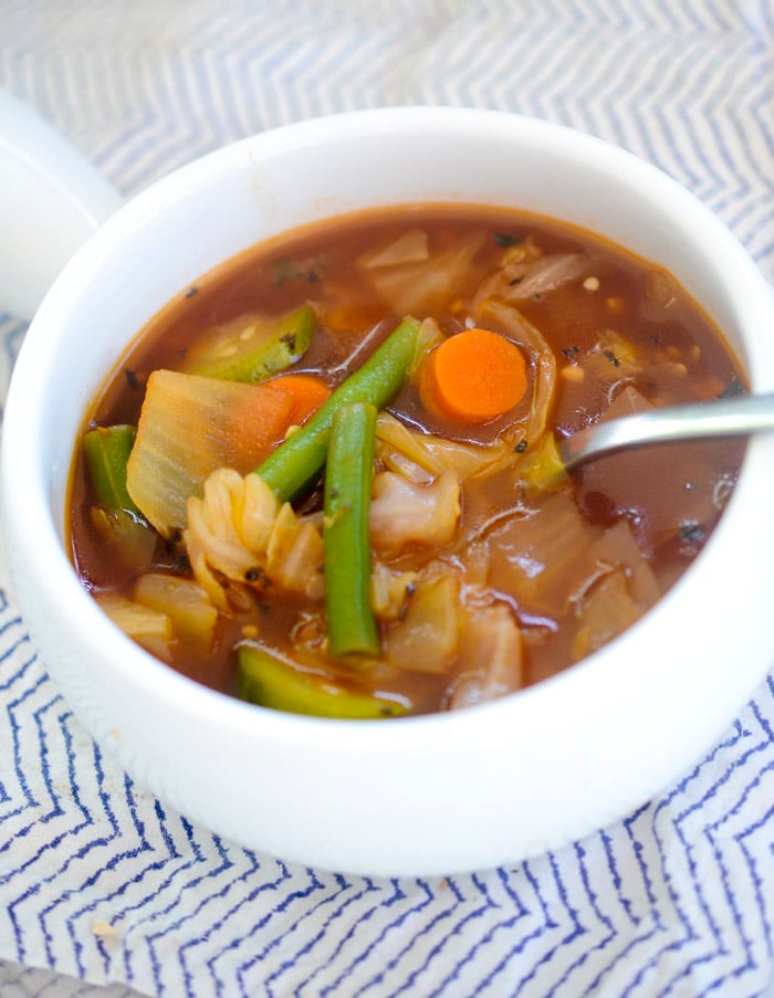 finished product of zero point cabbage soup with a soup spoon for serving in a white dish 