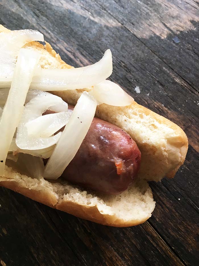Beer Brats - German Sausages submerged in onions and beer and cooked on the grill. These are a classic Summer time treat in the Midwest! 