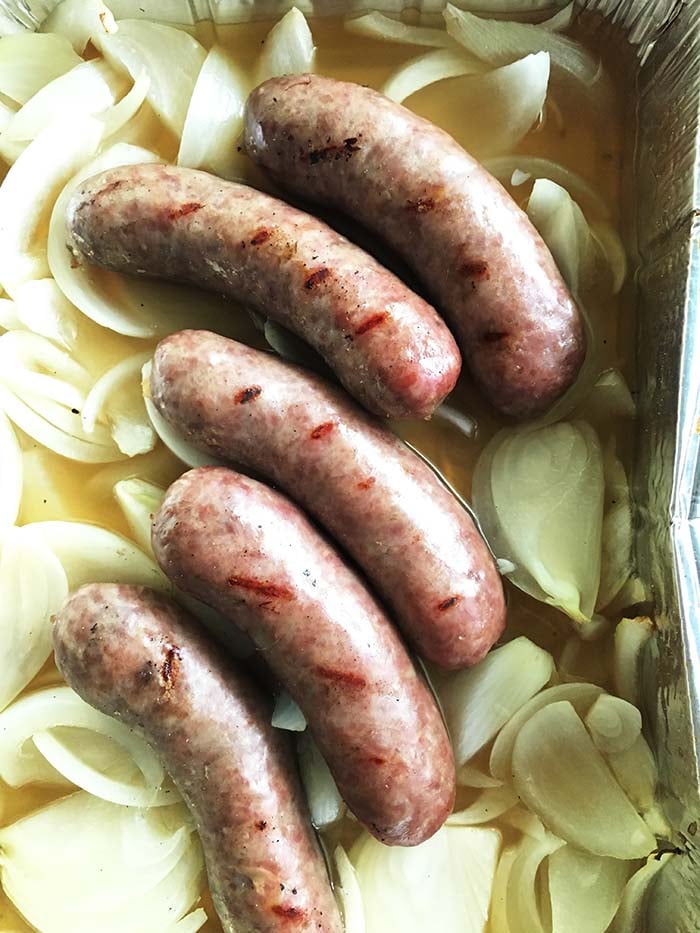Beer Brats - German Sausages submerged in onions and beer and cooked on the grill. These are a classic Summer time treat in the Midwest! 