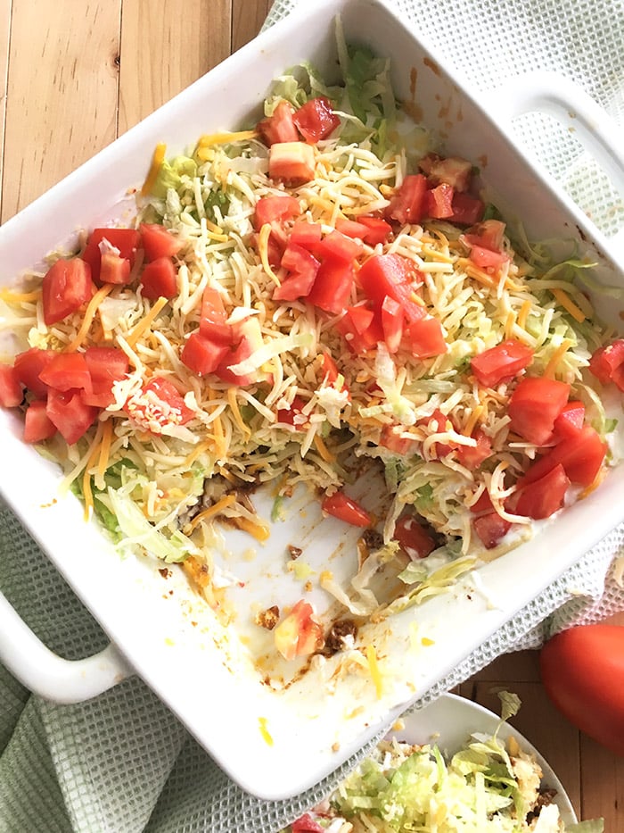 Taco Casserole - this taco casserole is made with layers of taco seasoned ground beef, a layer of baking mix, and taco toppings! Easy to throw together and great for a pot luck or Taco Tuesday. 