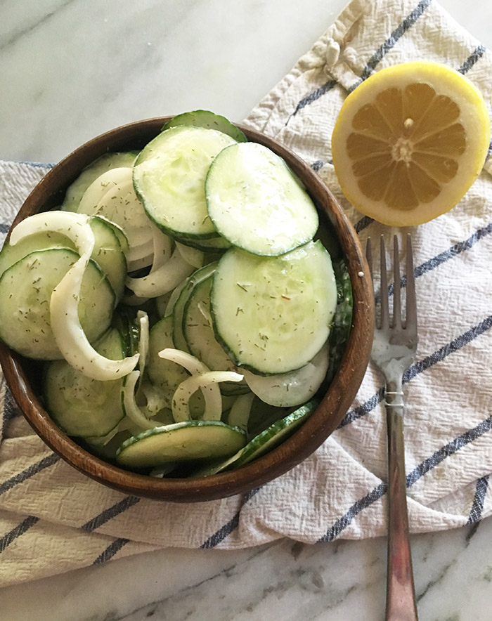 Creamy Cucumber Salad is the cook out food you need to bring to your 4th of July party. Made with healthy zero point ingredients such as greek yogurt. 