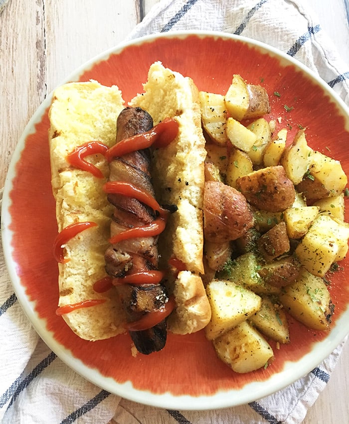How do you make a hot dog taste even better? Wrap it in some bacon of course! This bacon-wrapped hot dog is the best hot dog you will ever eat.