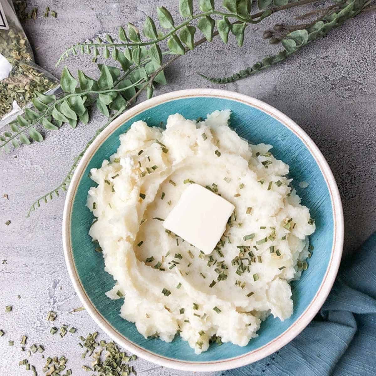 Slow cooker mashed potateos topped with butter. 