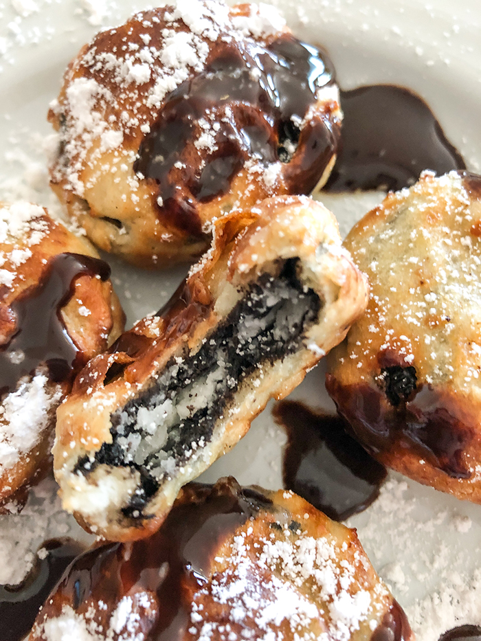 air fried Oreos drizzled with Hershey's chocolate syrup and dusted with powdered sugar. 