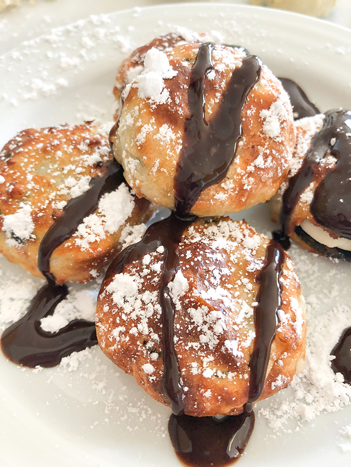 air fried Oreos drizzled with Hershey's chocolate syrup and dusted with powdered sugar. 