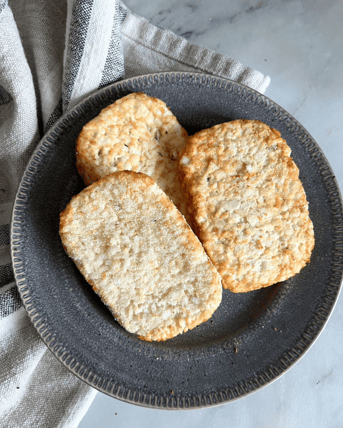 frozen hash brown patties on a grey plate 