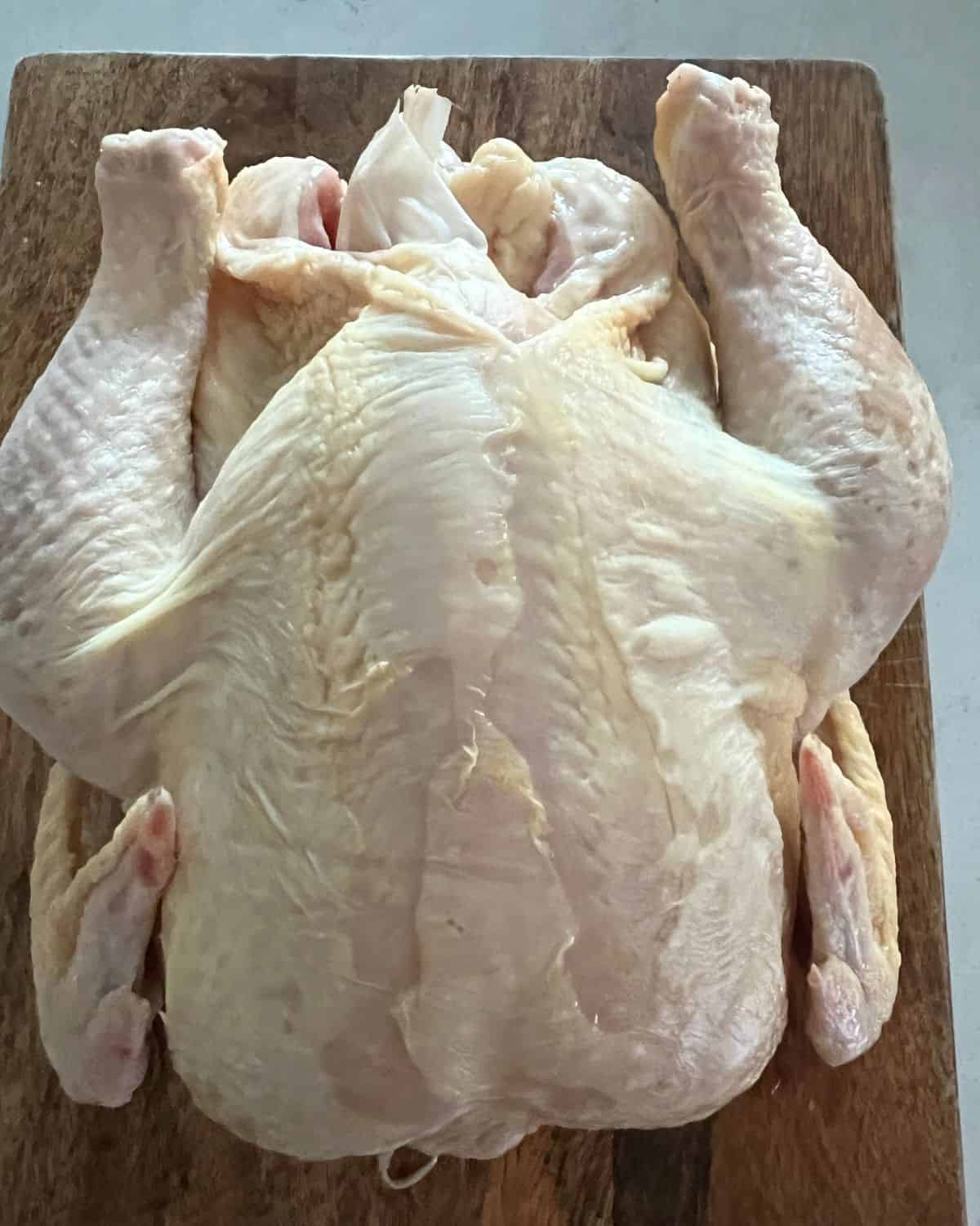 Finished unseasoned chicken that has been soaking in brine.