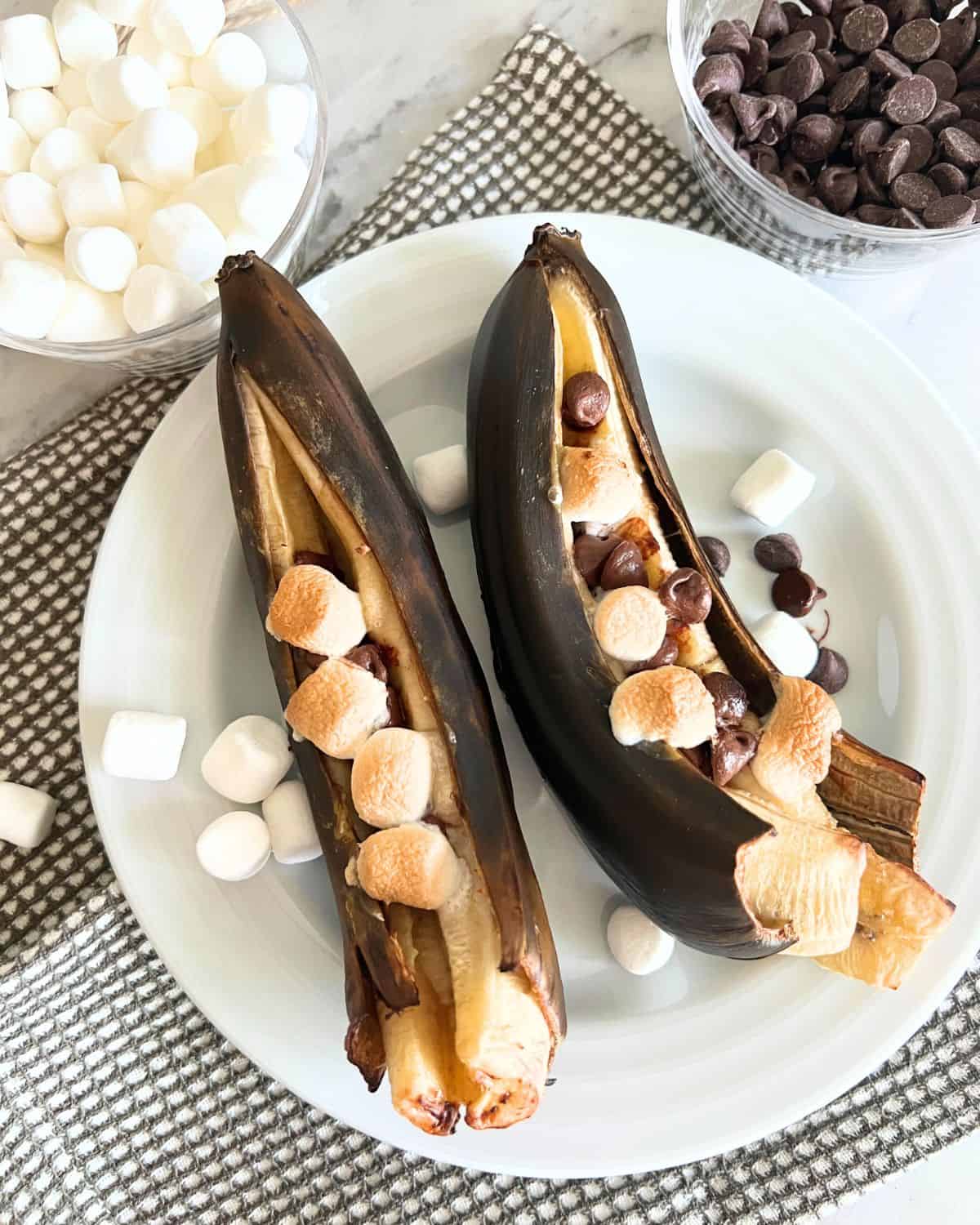 Grilled bananas topped with toasted marshmallows and chocolate chips. 
