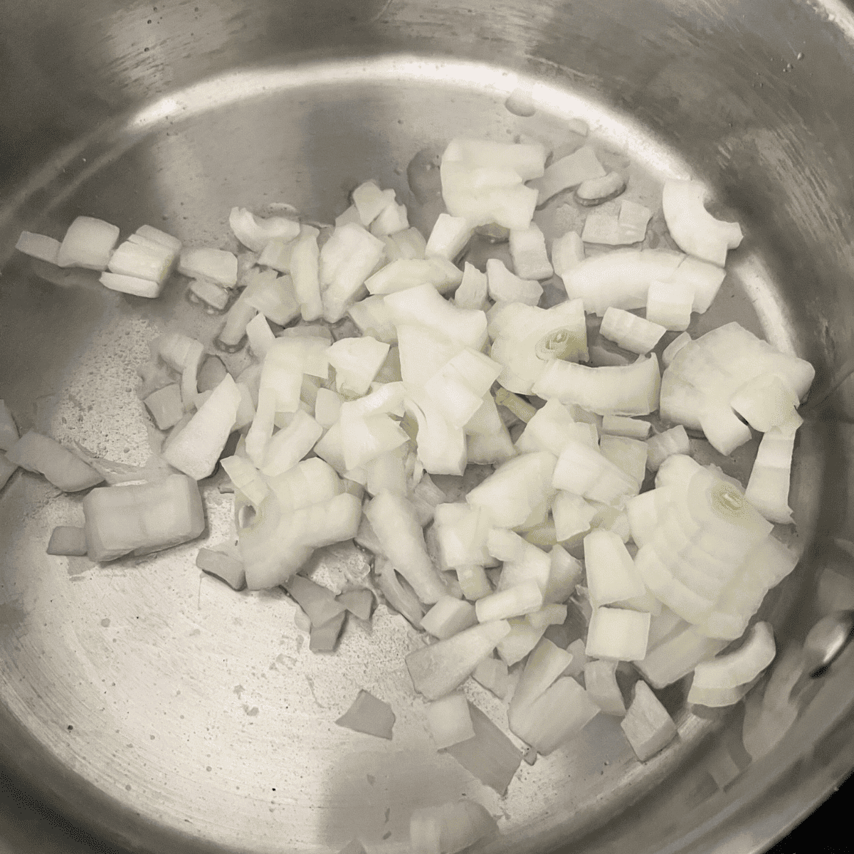 White onions cooking in a skillet 