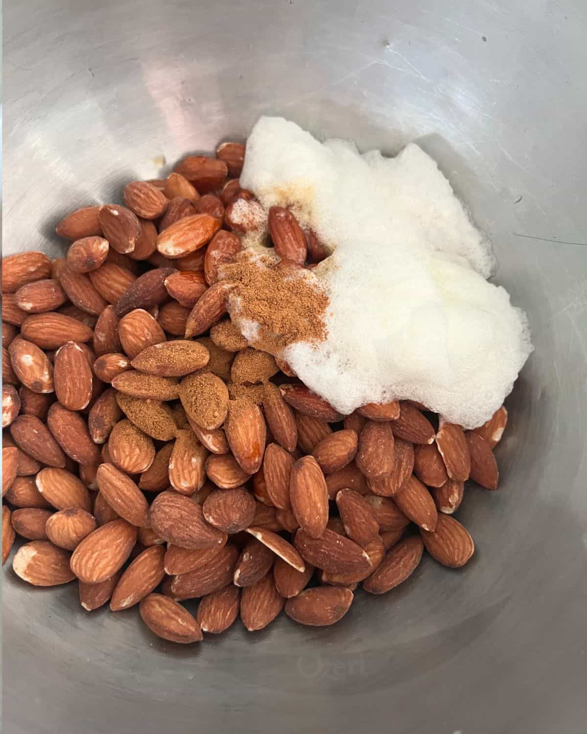 Egg whites, almonds, and seasonings mixed in a bowl. 