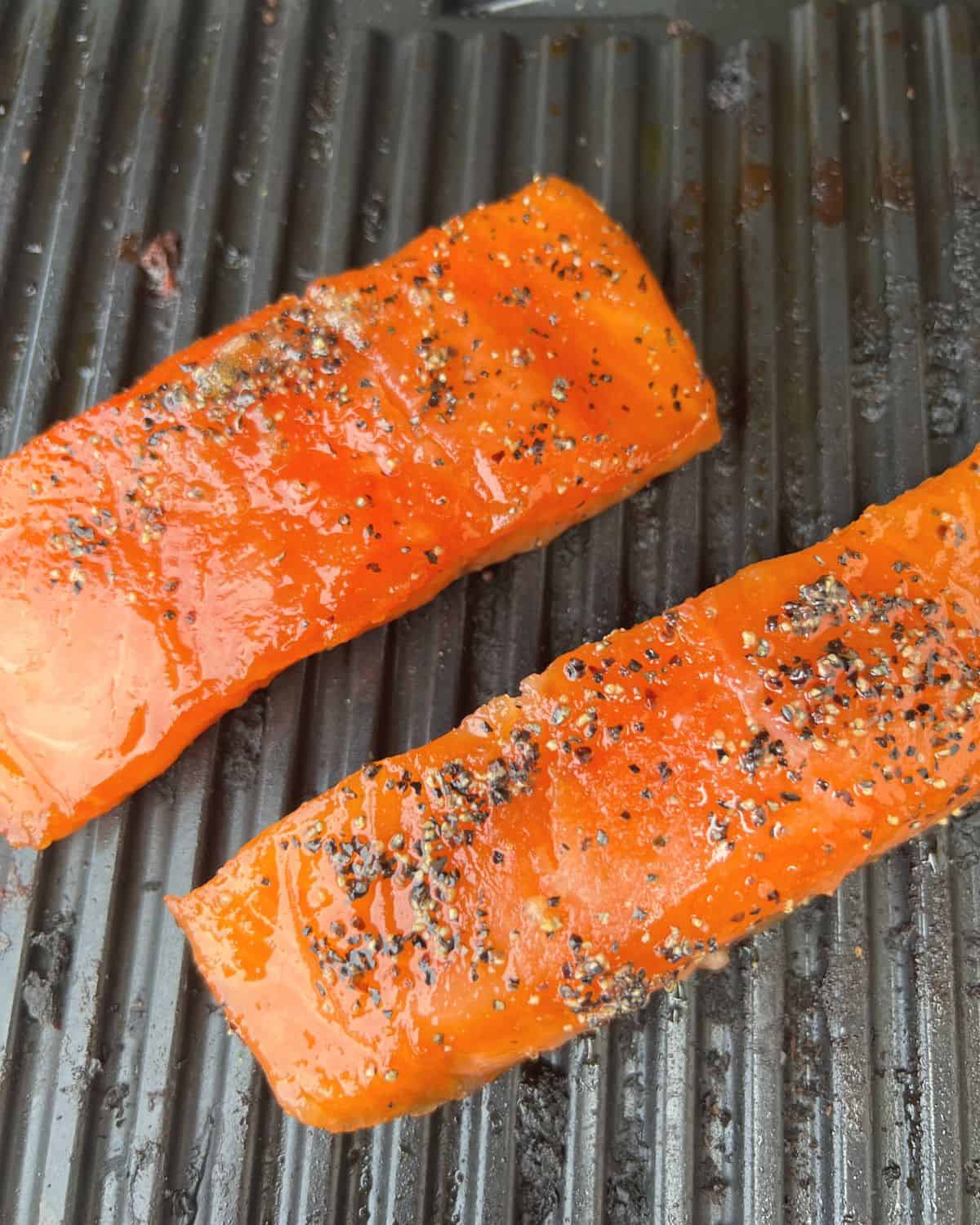 Brined salmon cooking on a smoker. 