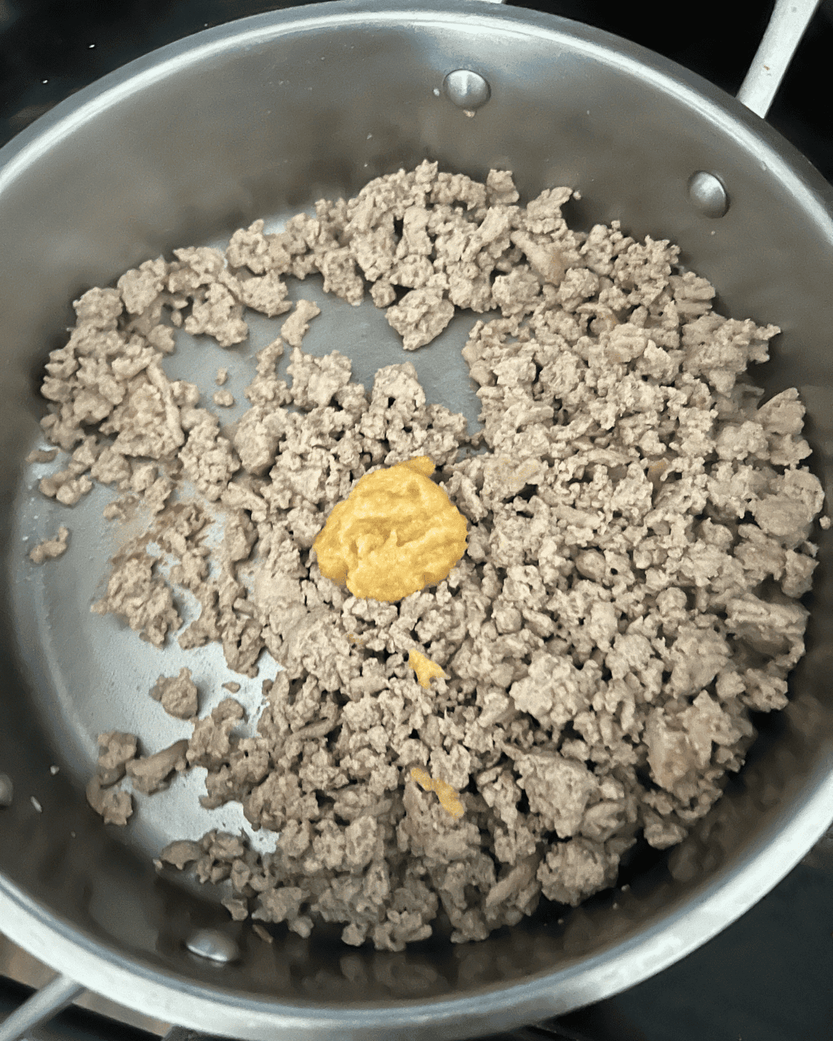 ginger and ground chicken cooked together in a skillet.