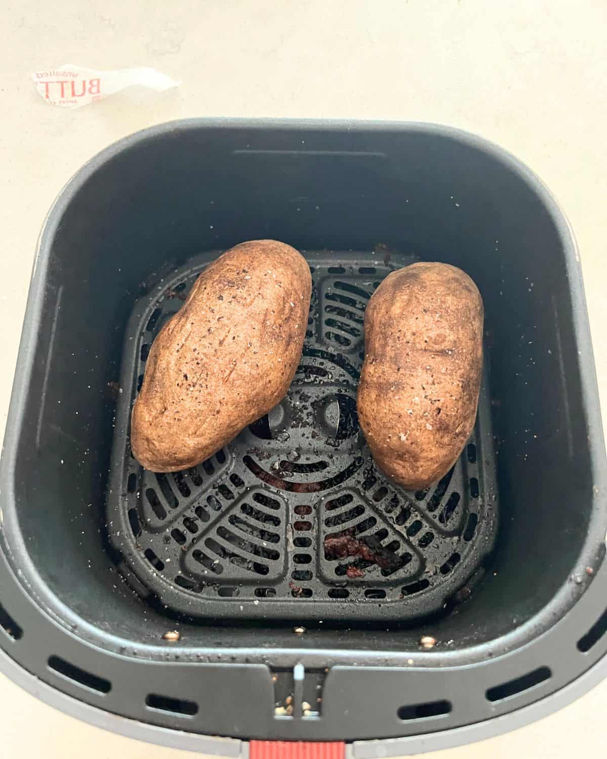 Crispy cooked air fried potatoes in an air fryer basket. 