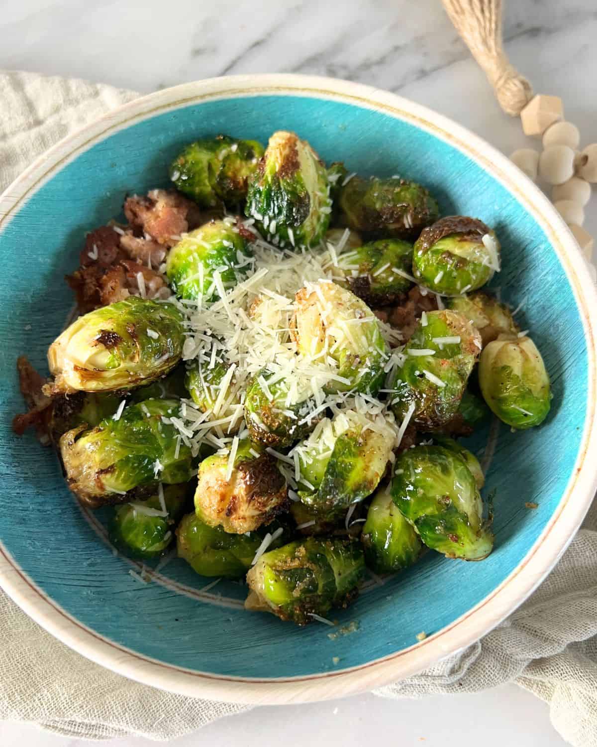 Brussel Sprouts with bacon in a blue bowl. 