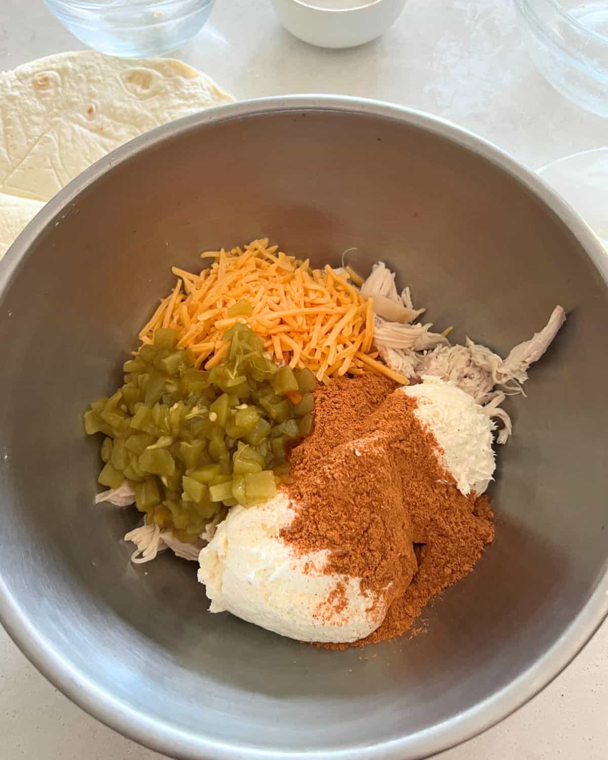 Ingredients for chimichangas together in a bowl. 
