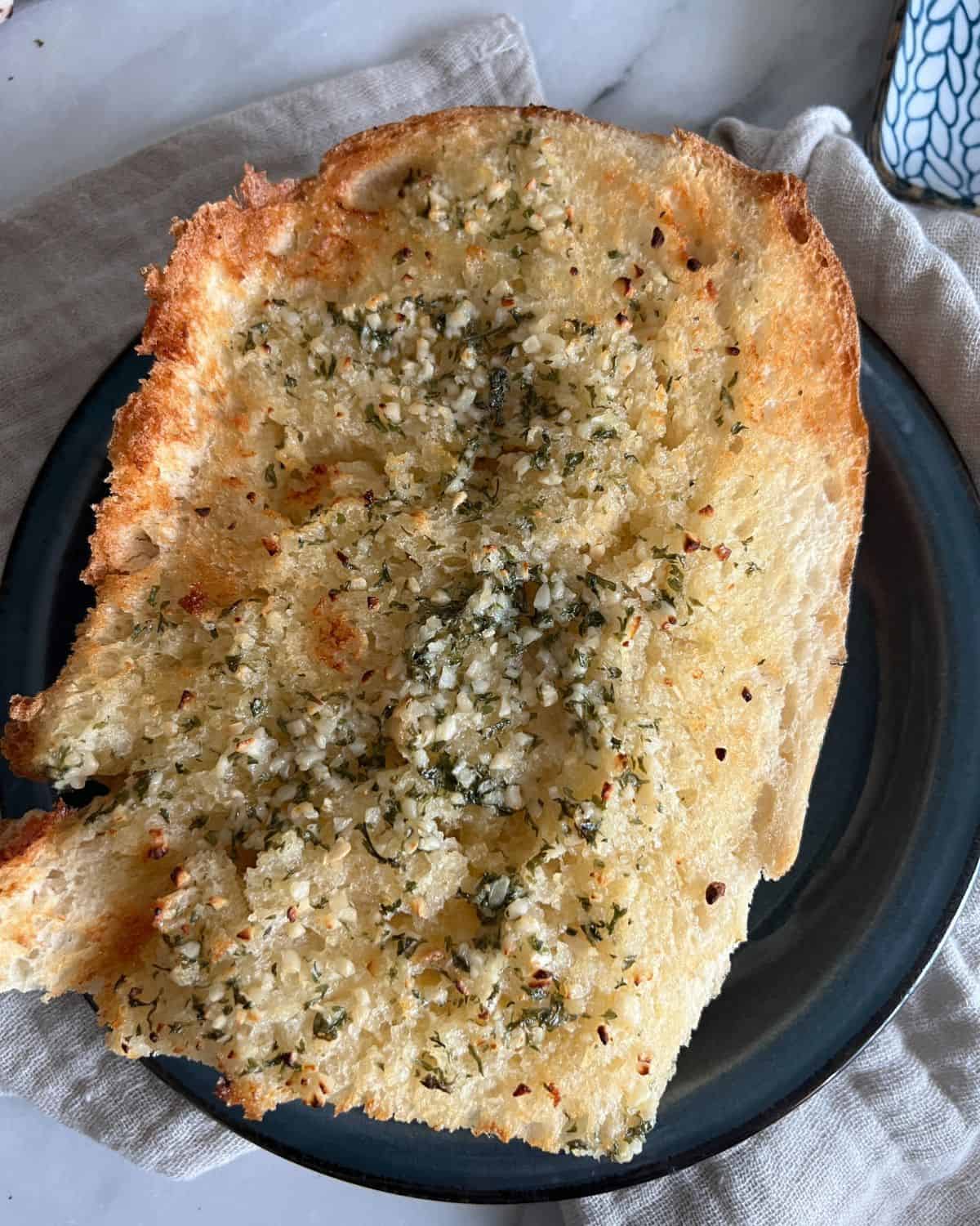 Air fryer garlic bread on a blue plate. 