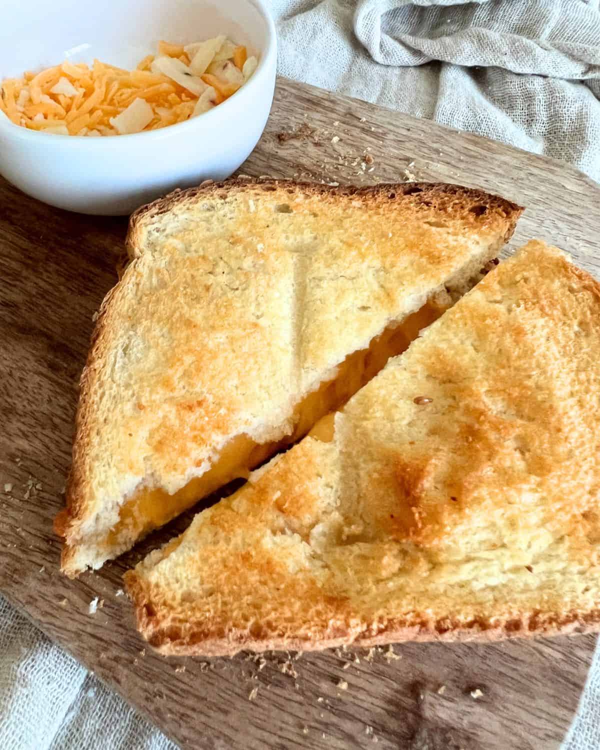 Air fryer grilled cheese served on a wooden cutting board. 
