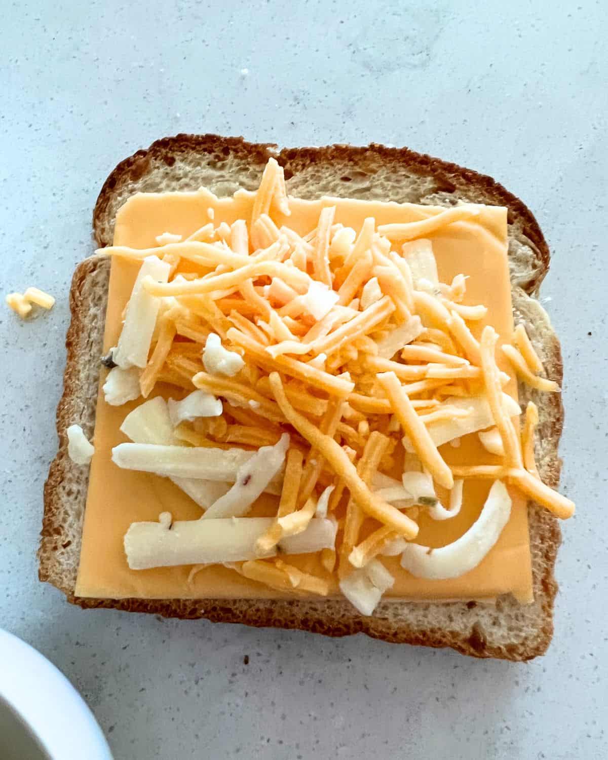 Cheese on top of bread for air fryer grilled cheese. 
