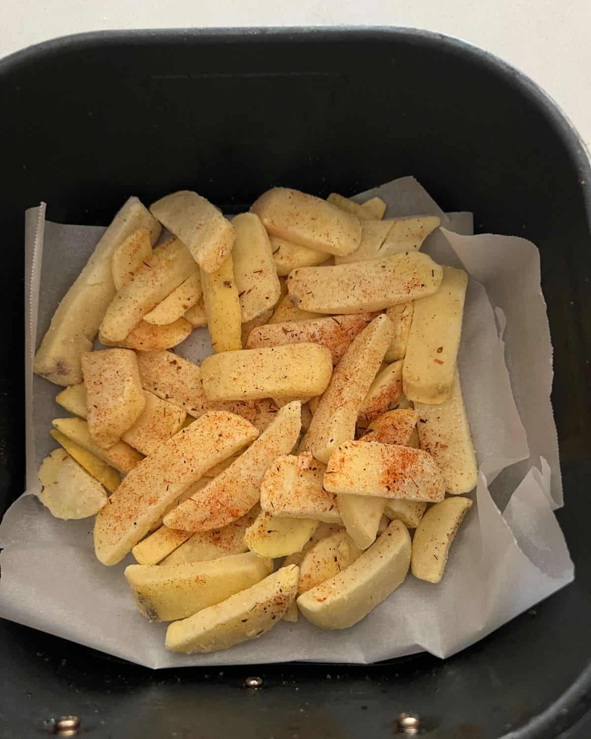 Seasoned french fries in air fryer. 