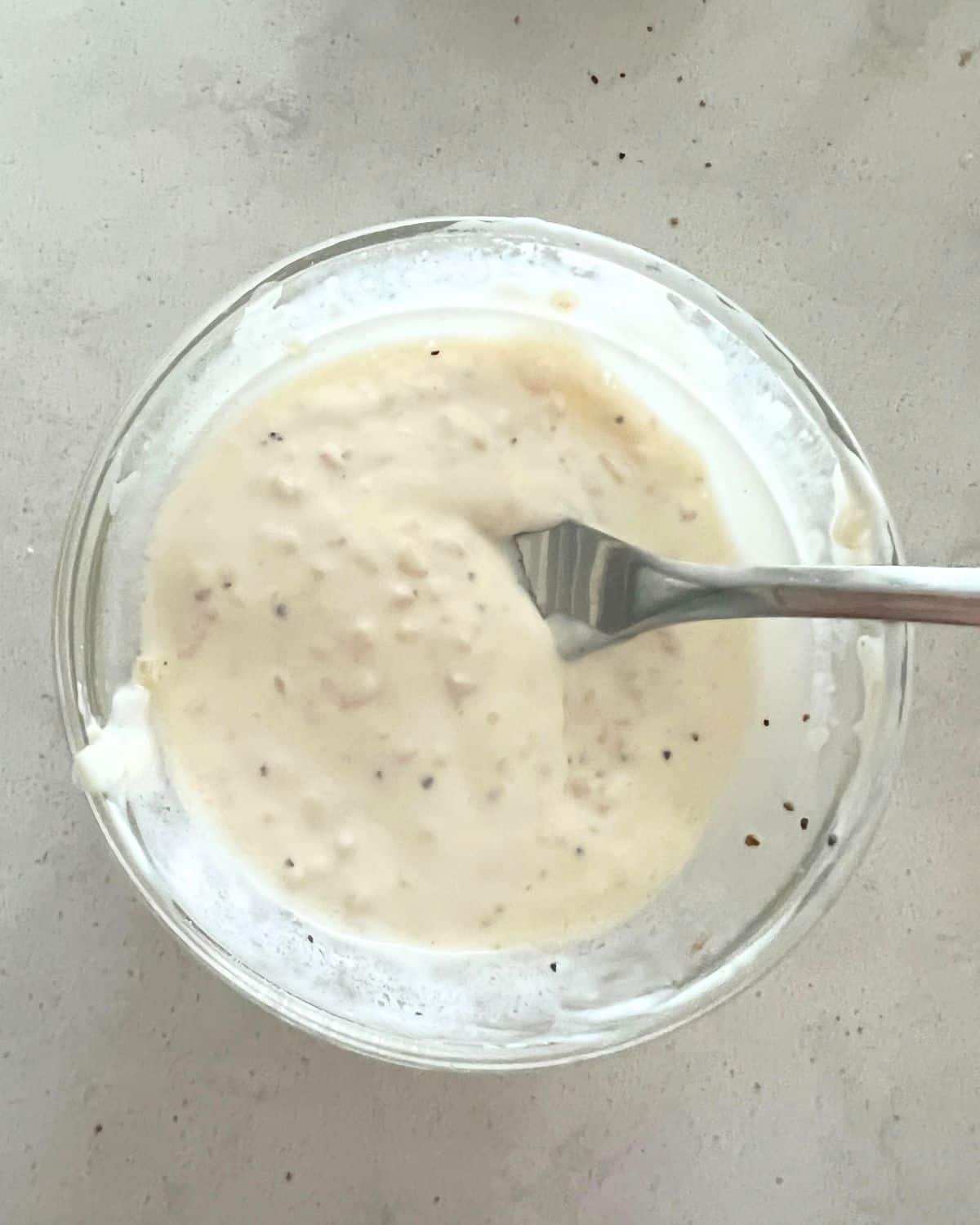 Mayo, garlic, and lemon juice in a bowl. 