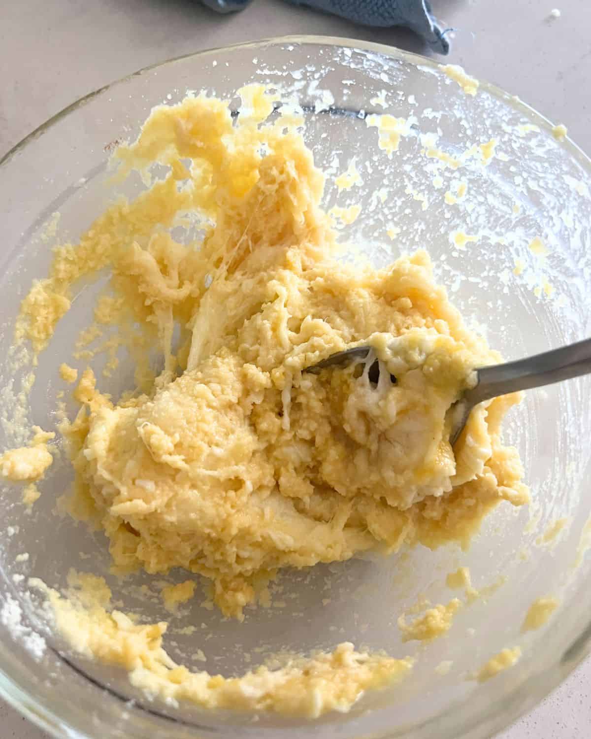 Fat head dough ingredients mixed together in a bowl. 
