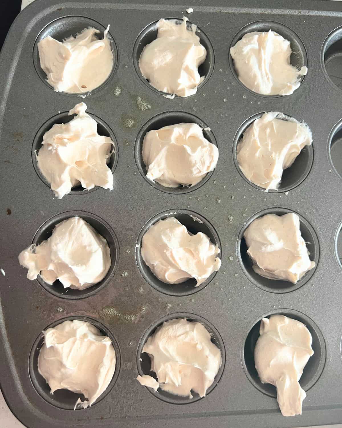 Frozen peanut butter mixture in mini muffin tins. 