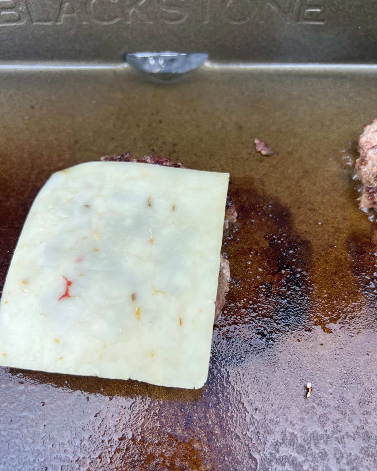 Melted pepper jack cheese on burger.