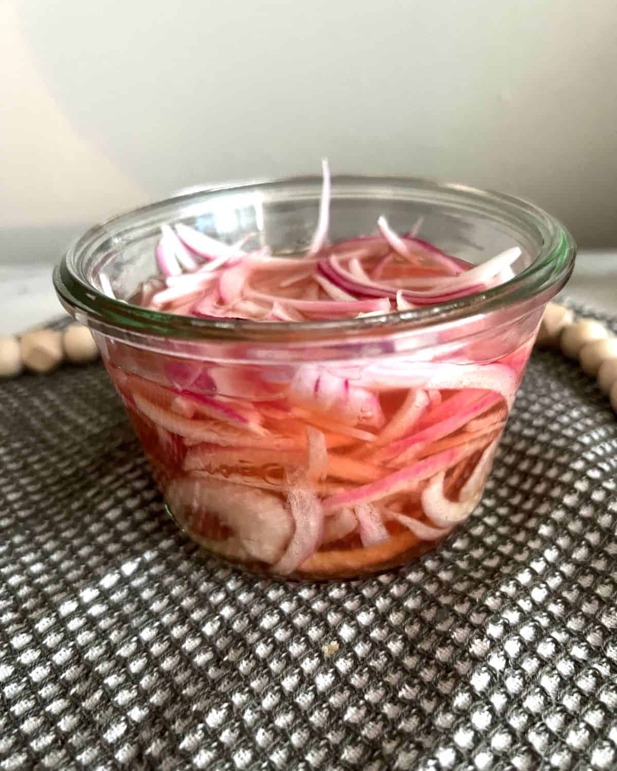 Pickled red onions in a jar ready to eat. 