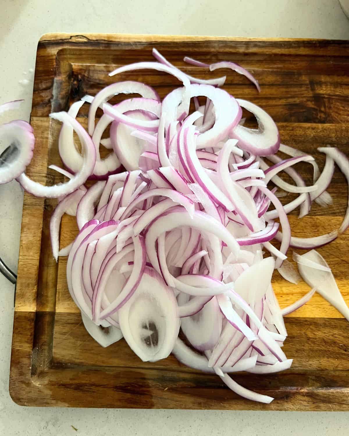 Thinly sliced red onions for pickled onions. 