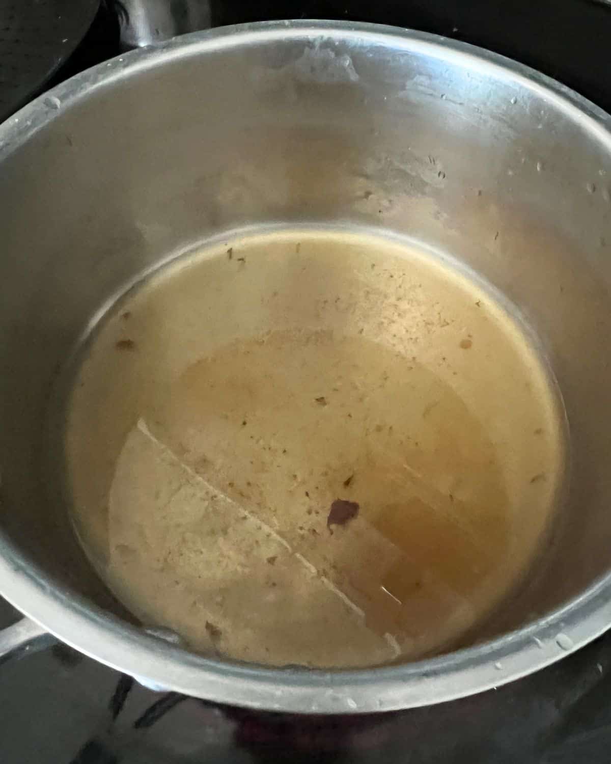 Vinegar, sugar, and limes in a sauce pan. 
