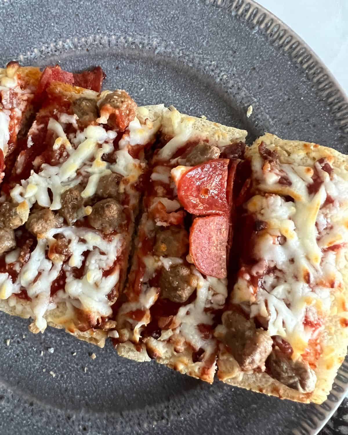 Air fried frozen pizza on a blue plate. 