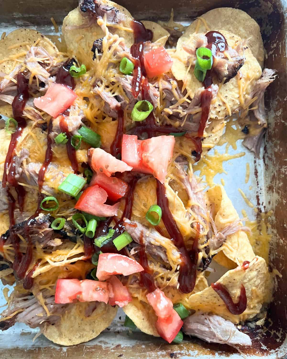 Pulled pork nachos with all the toppings. 