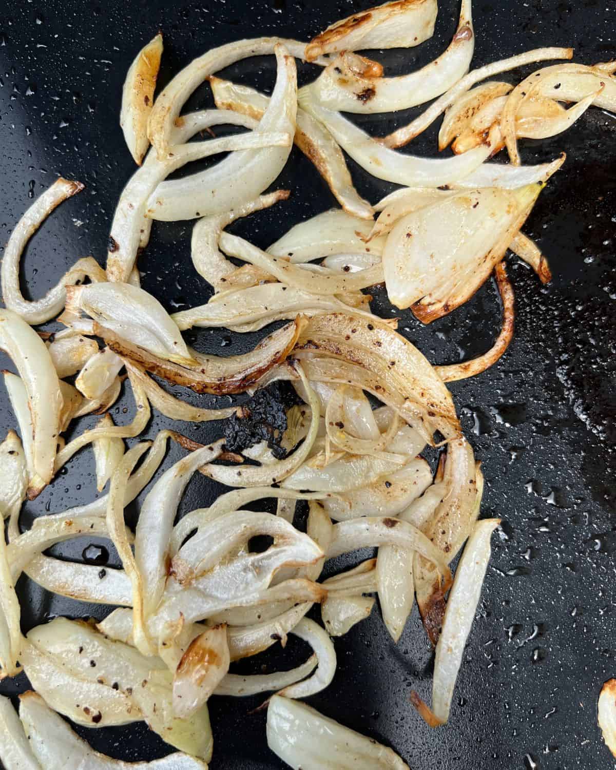 Cooked onions on a Blackstone grill. 