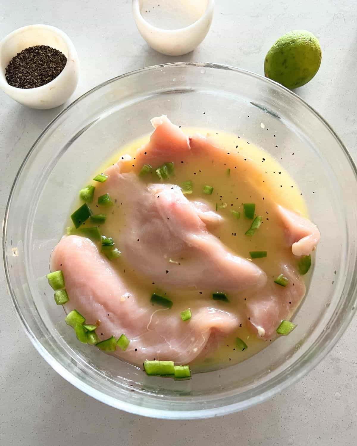 Tequila marinade with chicken in a bowl. 