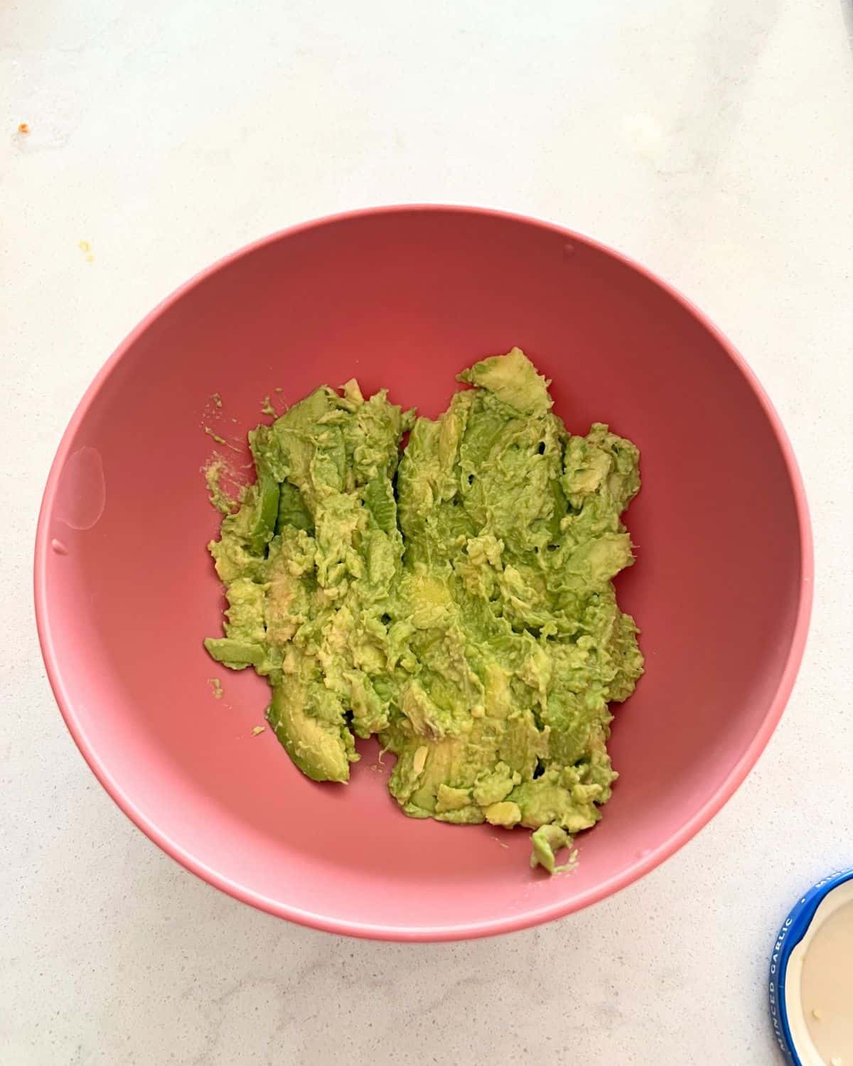 Mashed avocado and seasonings in a boowl. 