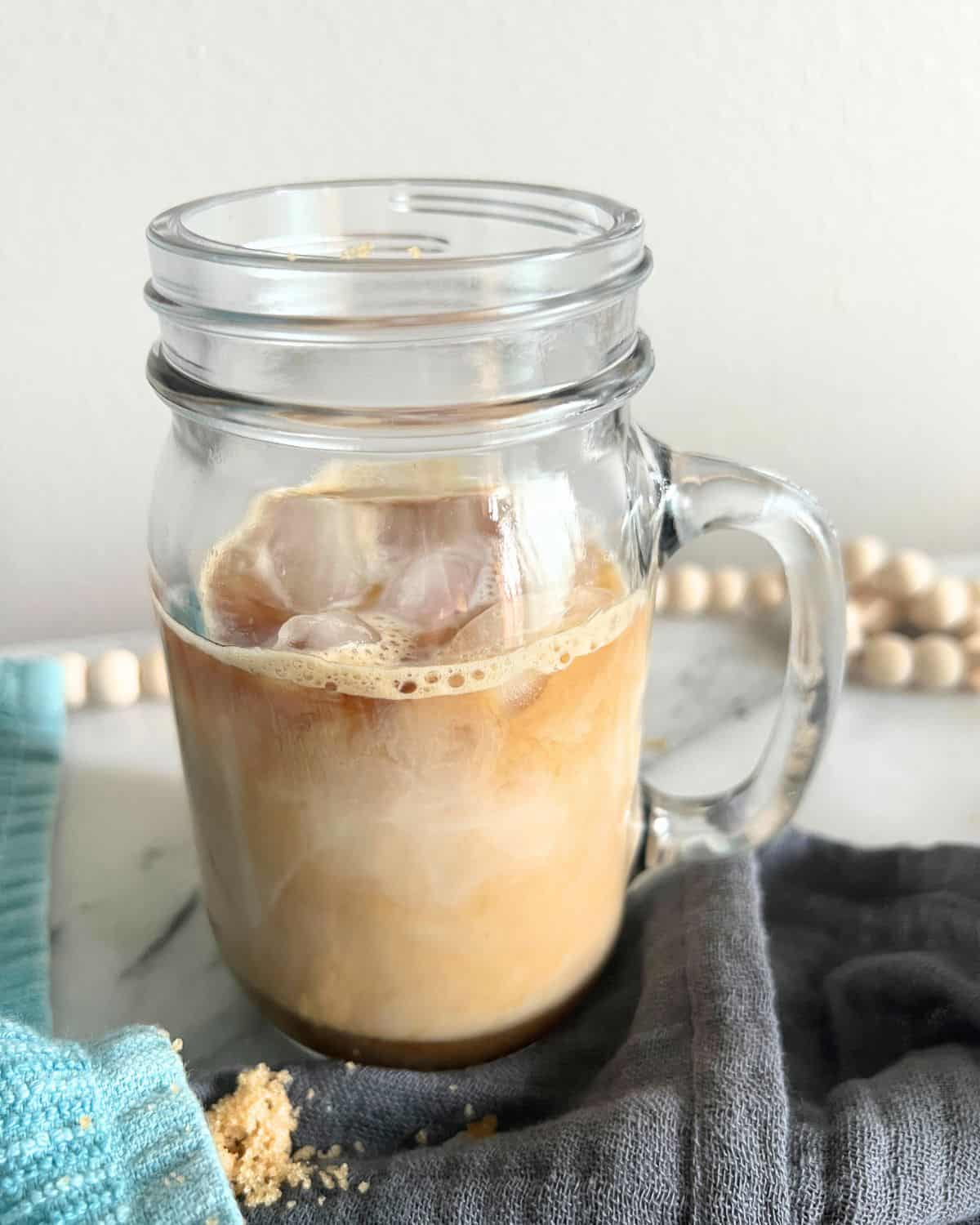 Brown Sugar Shaken Espresso poured into a glass jar.