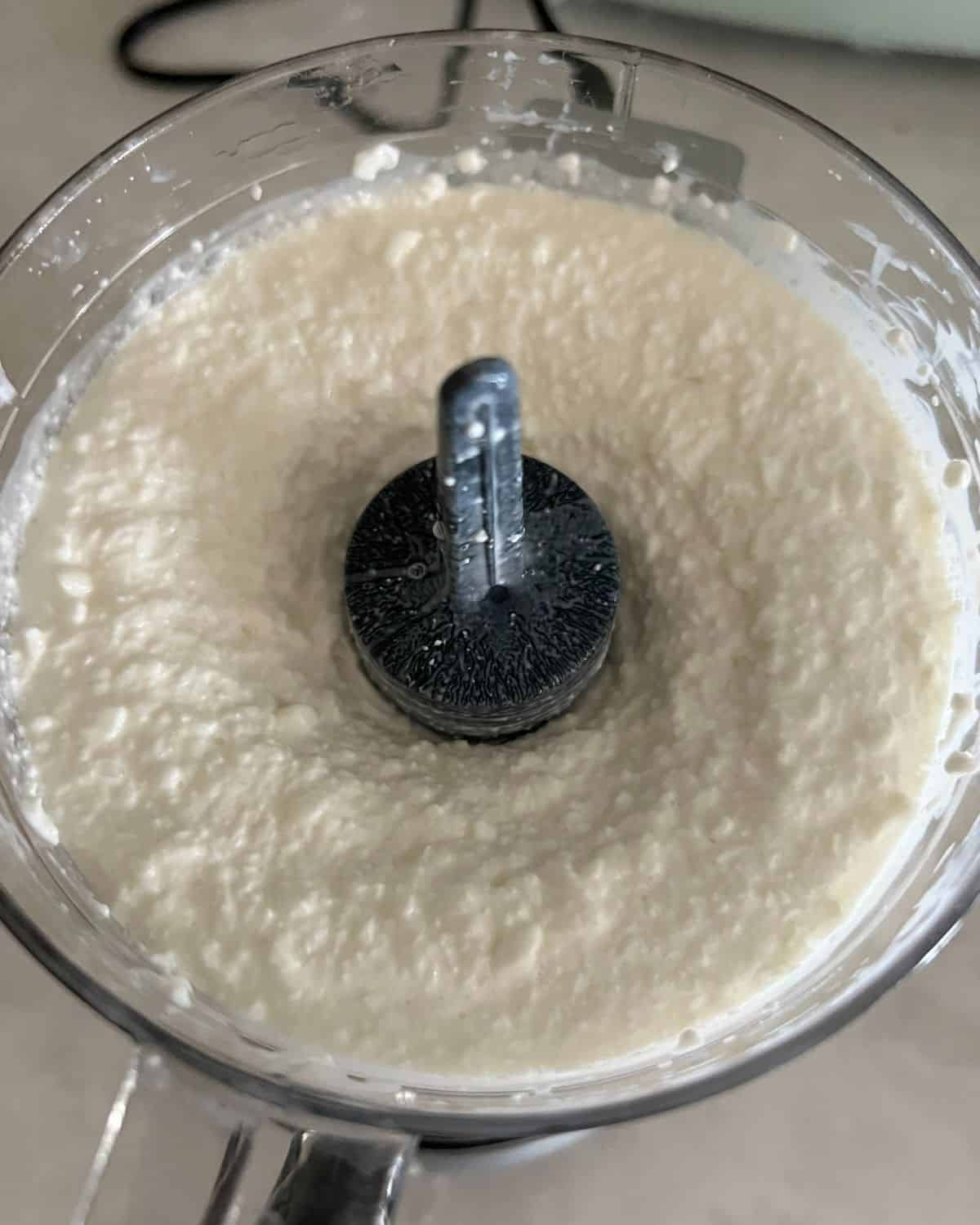 Blended cottage cheese in a food processor. 