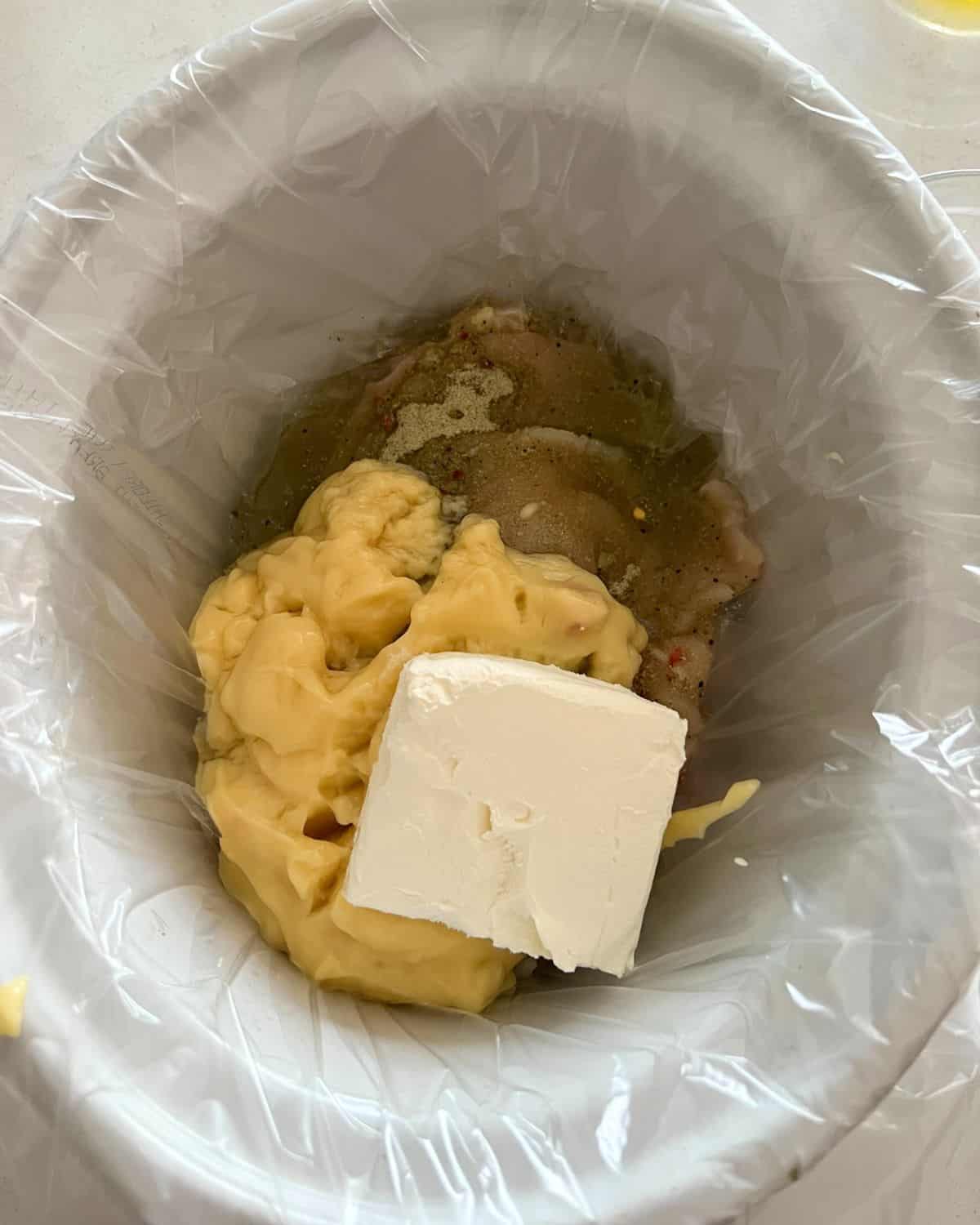 Ingredients for creamy Italian chicken in a crock pot. 