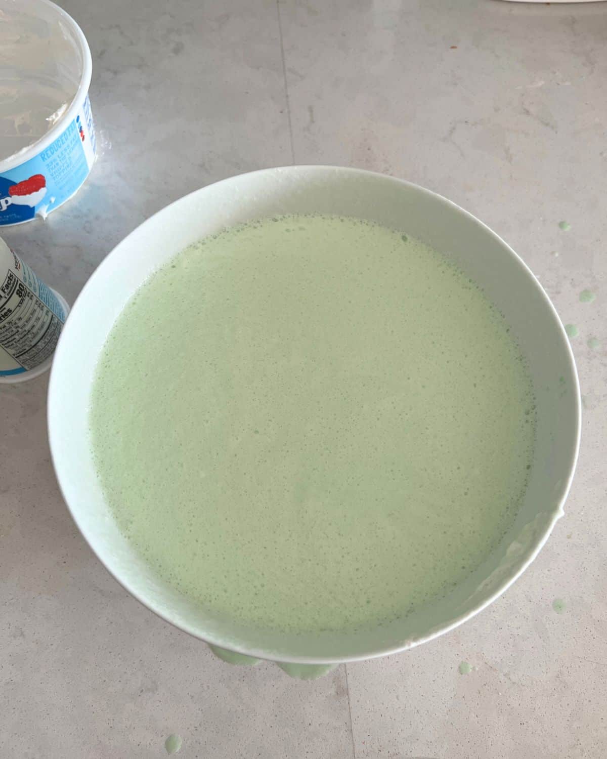 Yogurt and Cool Whip combined in a bowl with gelatin.