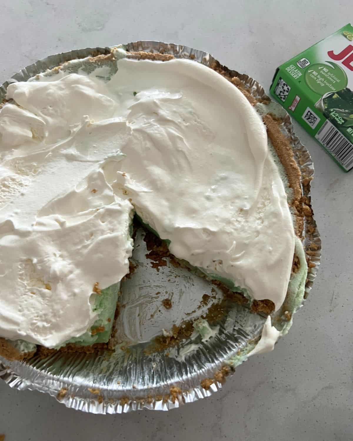 Jello key lime pie topped with whipped topping.