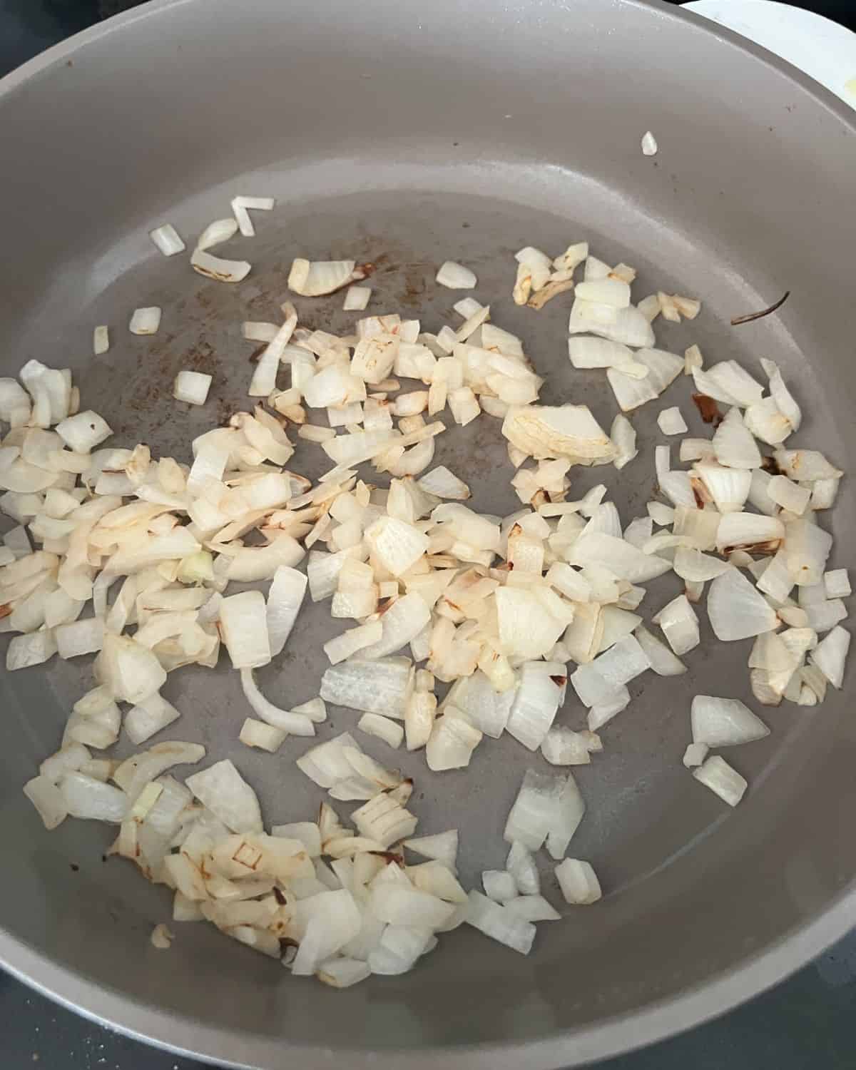 Onions cooking in a skillet. 