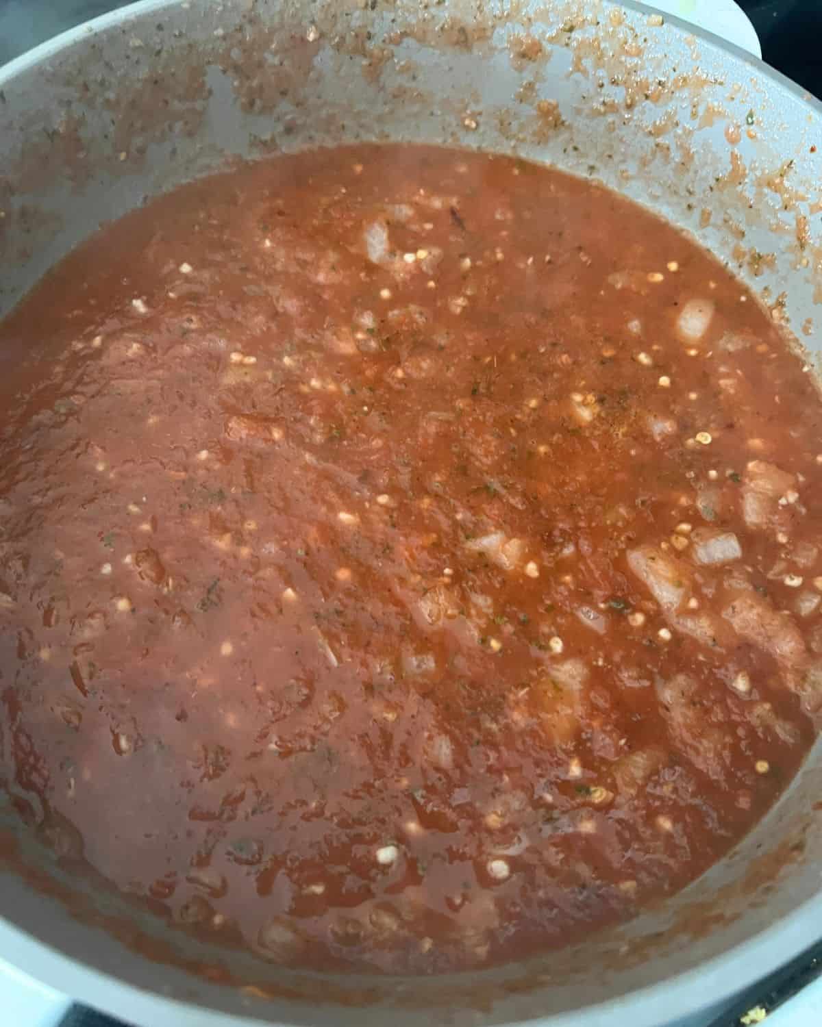 Ingredients for marinara sauce all together in a skillet. 